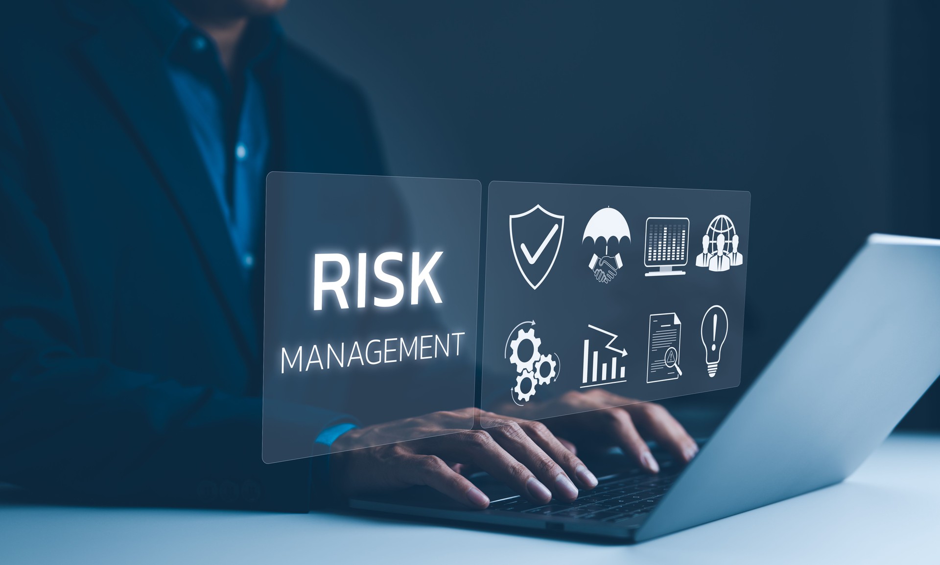 Corporate risk management strategy concept. A businessman is analyzing a virtual risk management interface with critical strategy icons on a laptop screen. Analyze risk assessment, analysis financial,